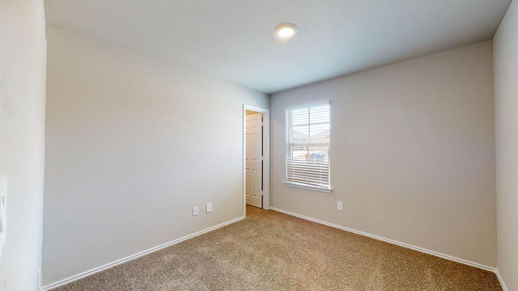 Carpeted spare room with baseboards