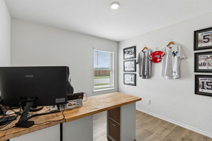 Home office with light wood-type flooring and baseboards Home office with light wood-type flooring and baseboards