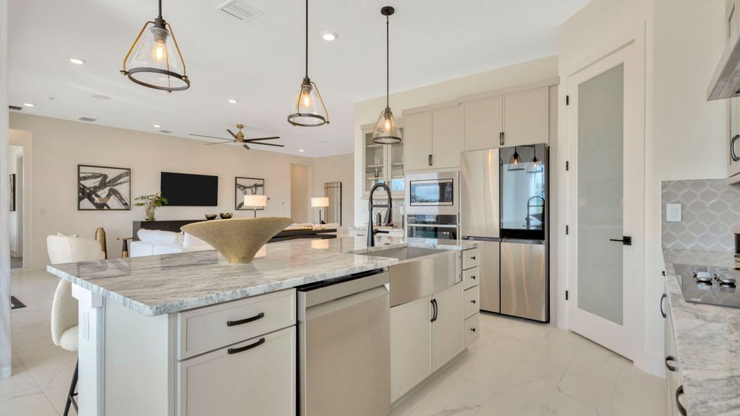 The Kitchen of a DRB Homes Grand Eider model, which is a home plan offered at Serengeti in Spring Hill, FL.