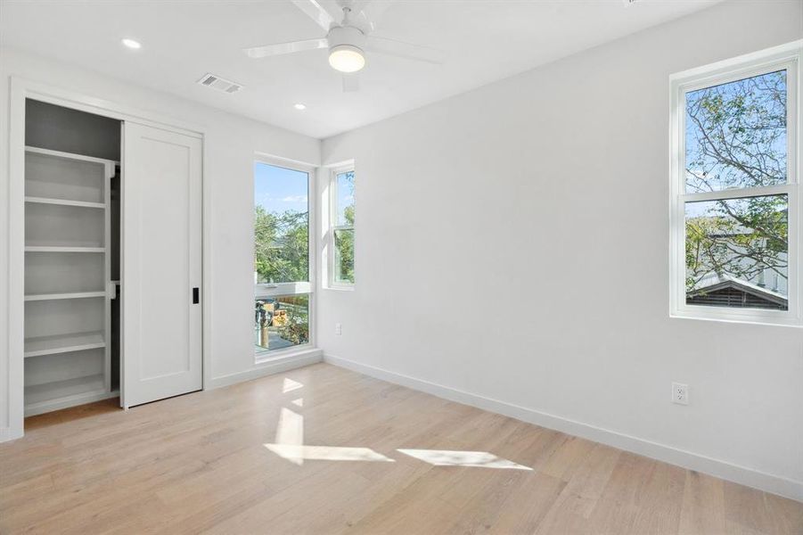 Unfurnished bedroom with light wood-style flooring, ceiling fan, recessed lighting, and a closet