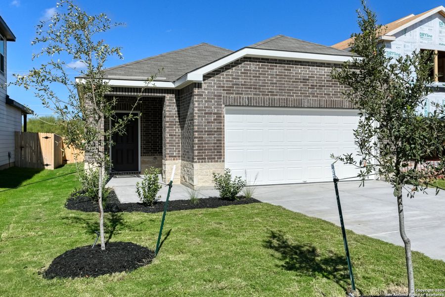 Front exterior of a new home in Meadows at Hennersby Hollow 40's, San Antonio, TX, highlighting curb appeal (Image 19). Front exterior of a new home in Meadows at Hennersby Hollow 40's, San Antonio, TX, highlighting curb appeal (Image 19).