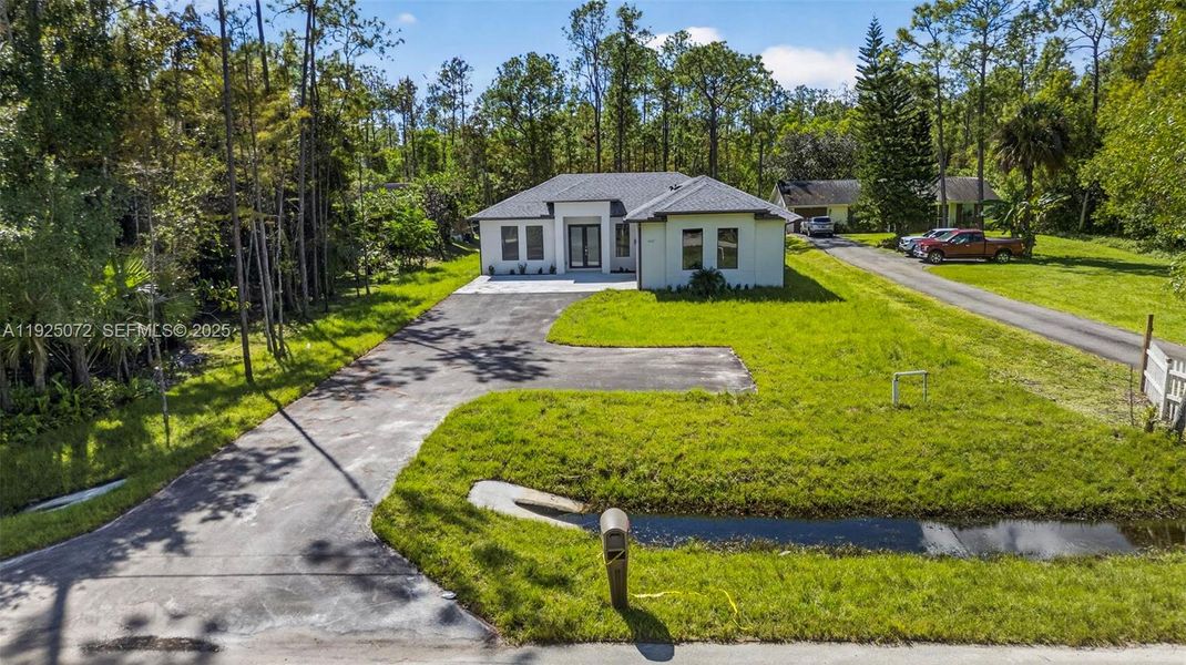 Front exterior of a new home in , Naples, FL, highlighting curb appeal (Image 21).