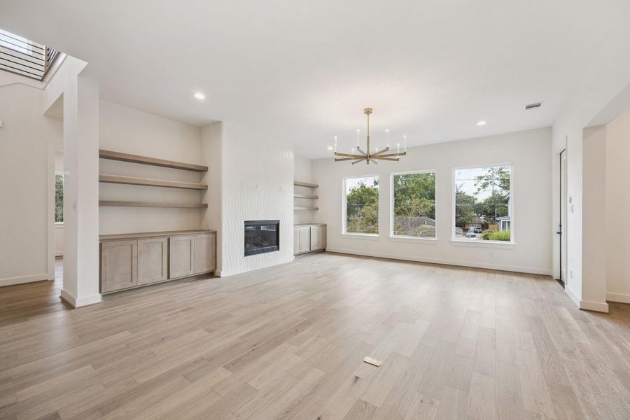 2211 Saxon welcomes you with a spacious great room, high ceilings, an abundance of natural light and first-rate design. The oversized windows overlook the backyard. A study/bedroom and full bath are just through the opening between the staircase and fireplace wall. 2211 Saxon welcomes you with a spacious great room, high ceilings, an abundance of natural light and first-rate design. The oversized windows overlook the backyard. A study/bedroom and full bath are just through the opening between the staircase and fireplace wall.