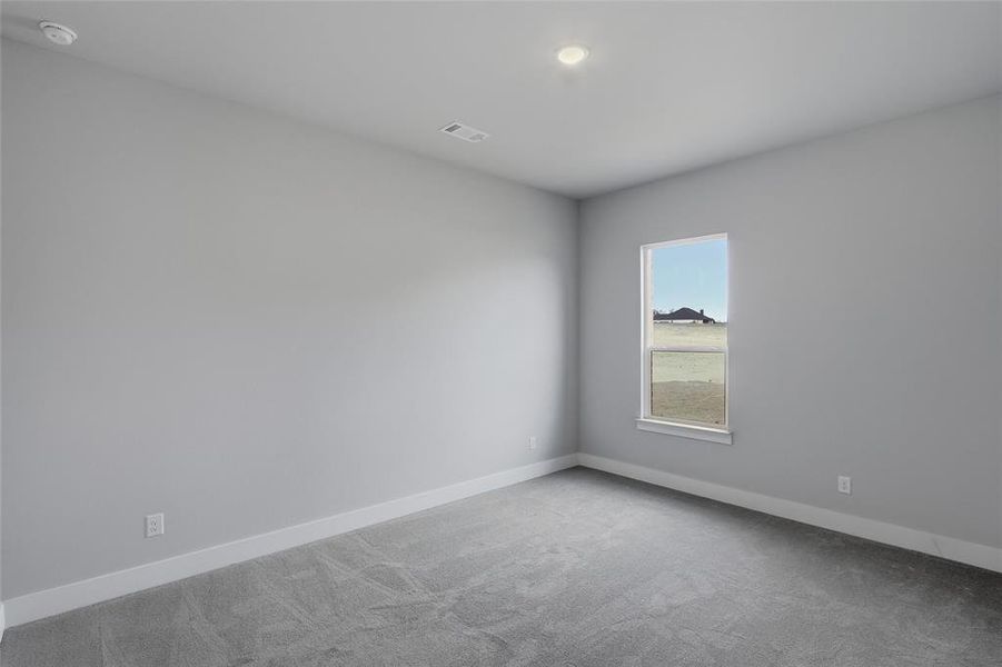 Carpeted empty room with baseboards