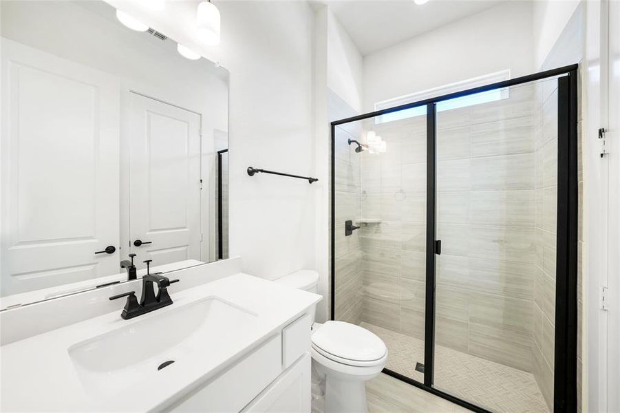 Bathroom with a stall shower and vanity