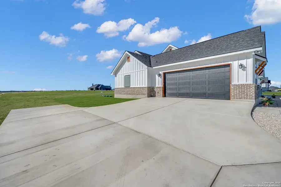 Front exterior of a new home in , La Vernia, TX, highlighting curb appeal (Image 1).