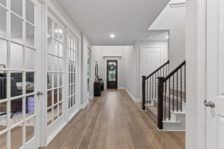 Foyer with stairs, light wood-style floors, recessed lighting, and french doors Foyer with stairs, light wood-style floors, recessed lighting, and french doors