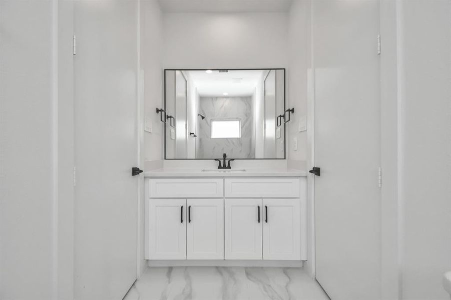 Picturesque large vanity and ample cabinet space complete the luxurious aesthetics of this gorgeous Jack and Jill