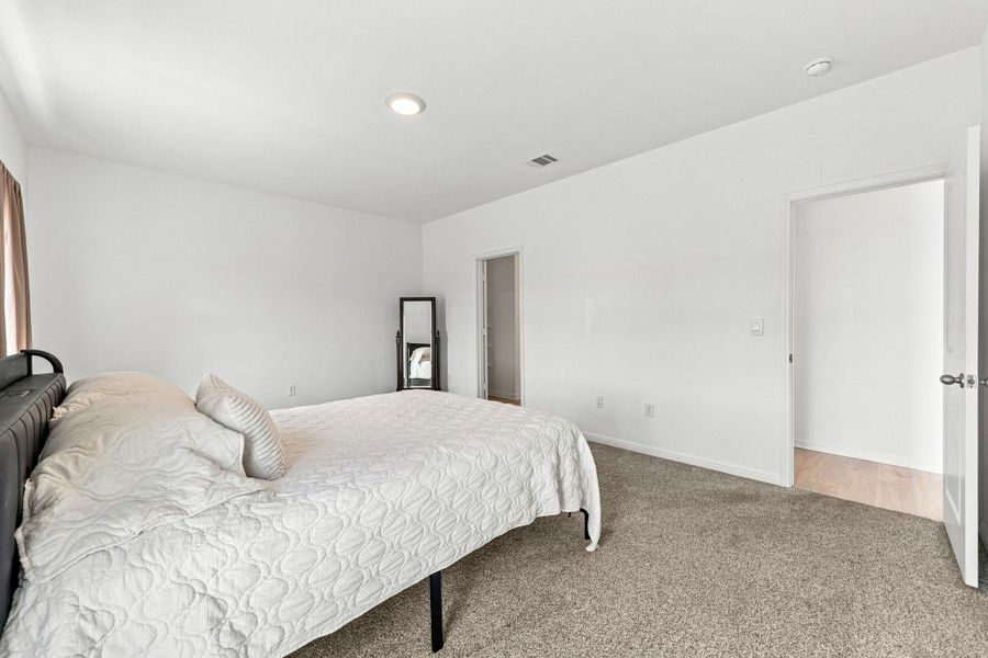 Plush carpeting and crisp neutral walls define this quiet personal retreat.