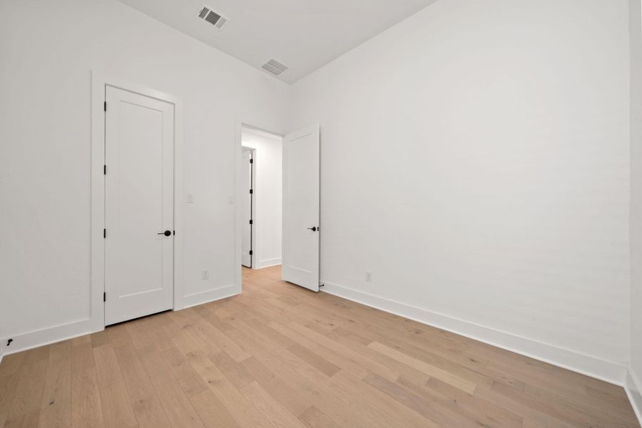 Unfurnished bedroom with light wood-type flooring and baseboards