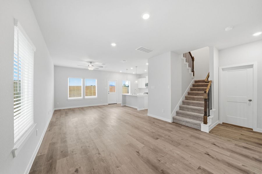 A large empty room with a wood floor and white walls. A large empty room with a wood floor and white walls.