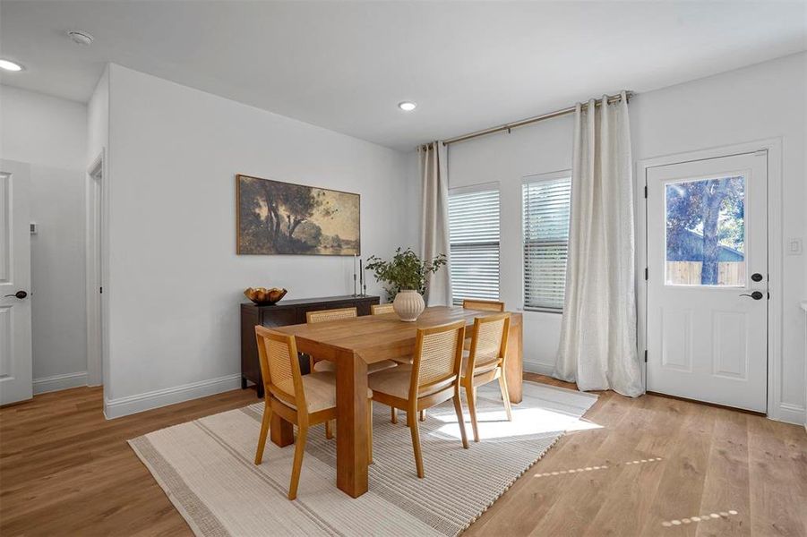 Dining area with light hardwood / wood-style flooring