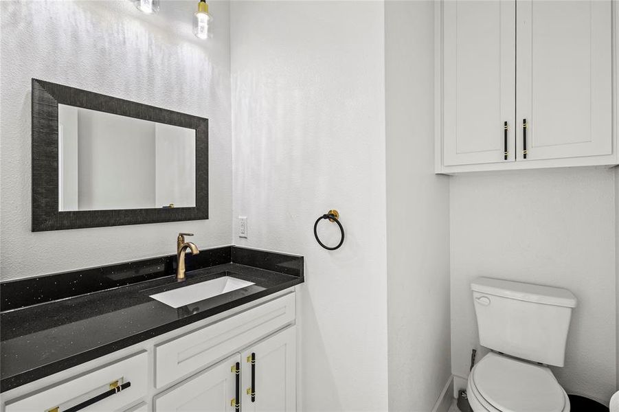 Bathroom featuring vanity and toilet Bathroom featuring vanity and toilet