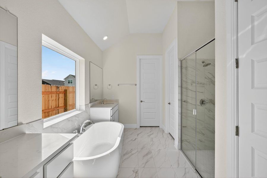 Bathroom featuring vanity, a marble finish shower, a soaking tub, light marble finish floors, and recessed lighting Bathroom featuring vanity, a marble finish shower, a soaking tub, light marble finish floors, and recessed lighting