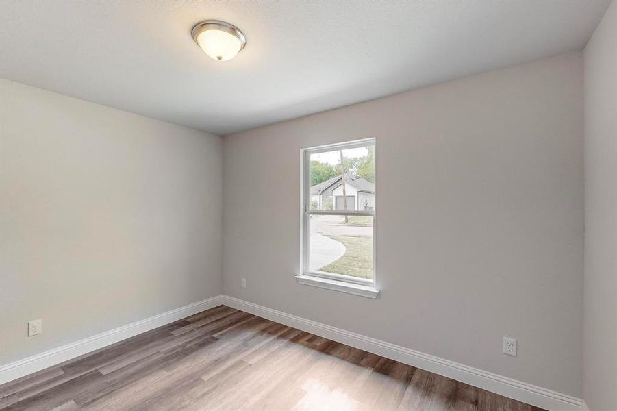 Unfurnished room with hardwood / wood-style flooring