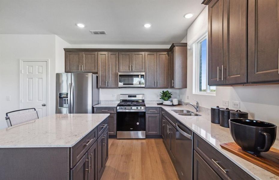 Spacious kitchen with eat-in bartop island *Model Representation* Spacious kitchen with eat-in bartop island *Model Representation*