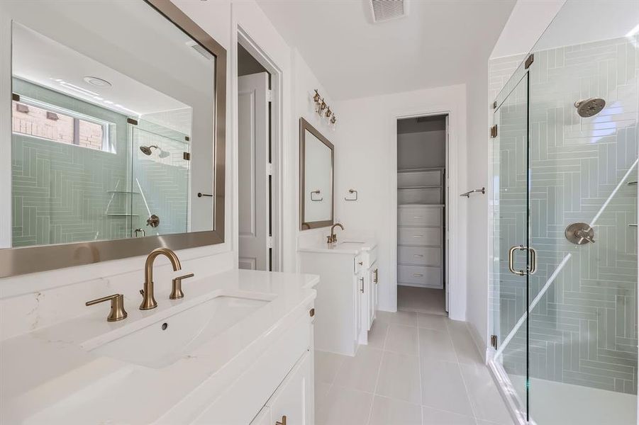 Bathroom featuring walk in shower, tile patterned flooring, and vanity