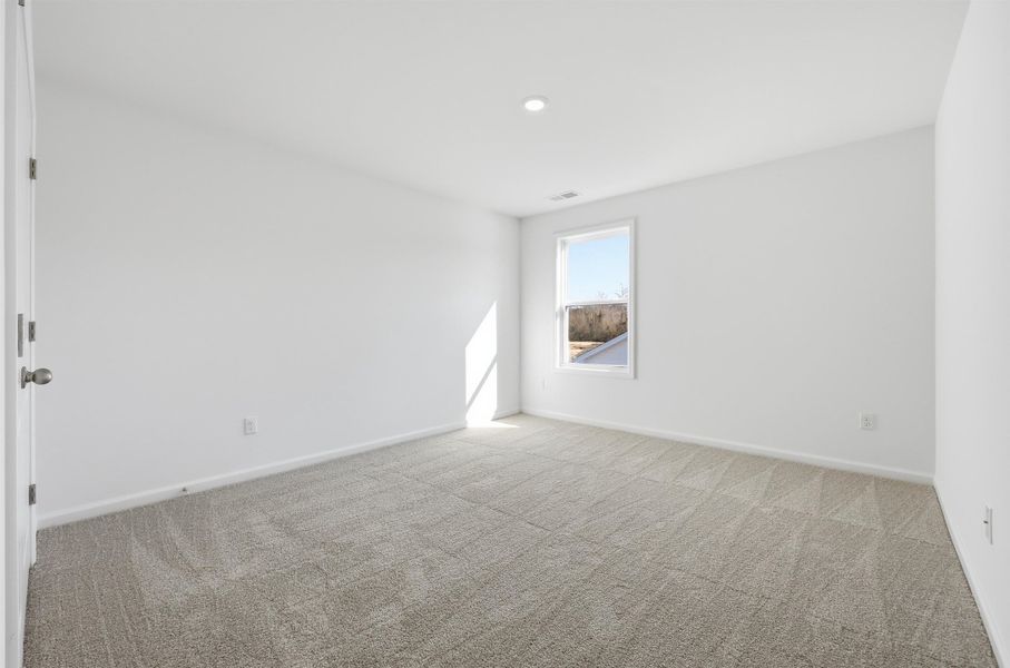 Unfurnished room with carpet flooring and baseboards Unfurnished room with carpet flooring and baseboards