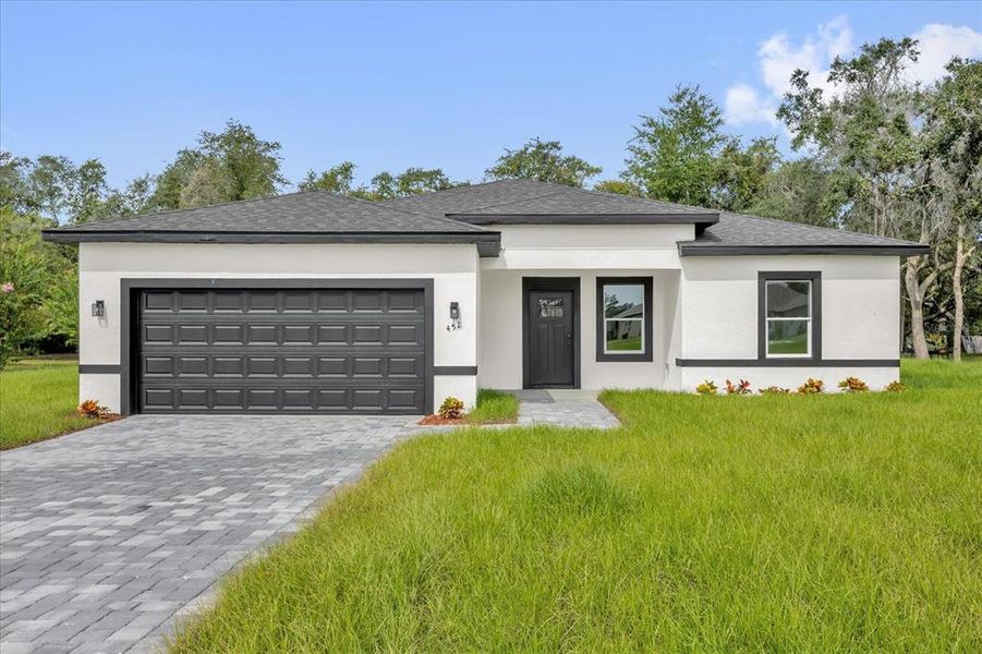 Front exterior of a new home in , Ocala, FL, highlighting curb appeal (Image 1).