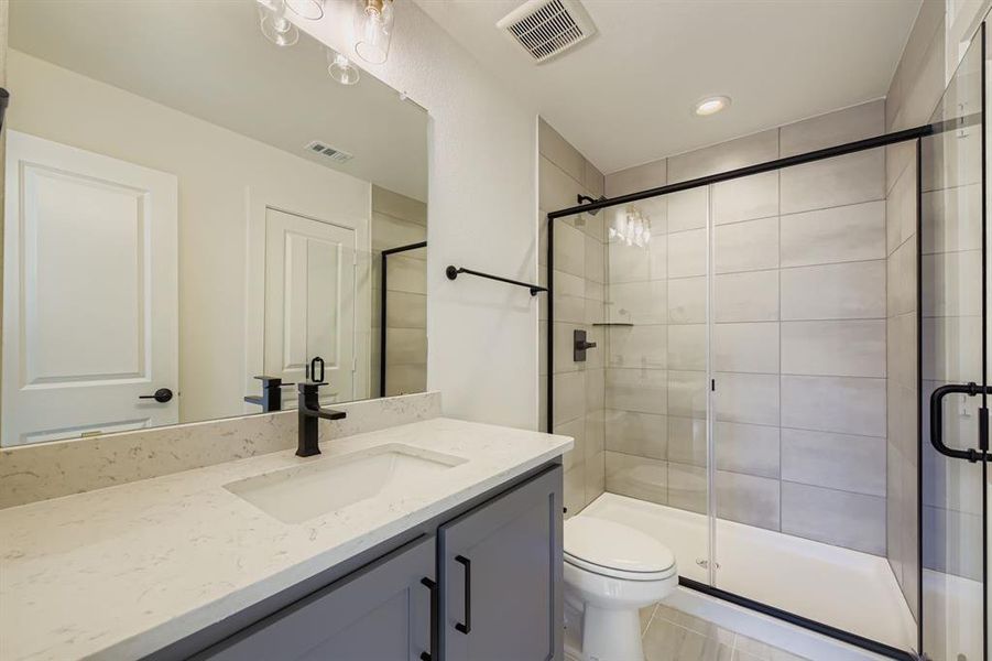 Full bathroom featuring vanity, a shower stall, and recessed lighting Full bathroom featuring vanity, a shower stall, and recessed lighting