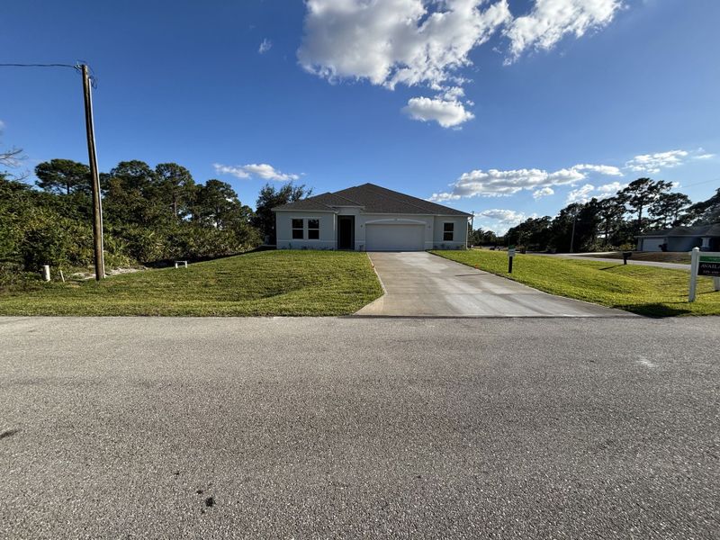 Front exterior of a new home in Lehigh Acres, Lehigh Acres, FL, highlighting curb appeal (Image 22).