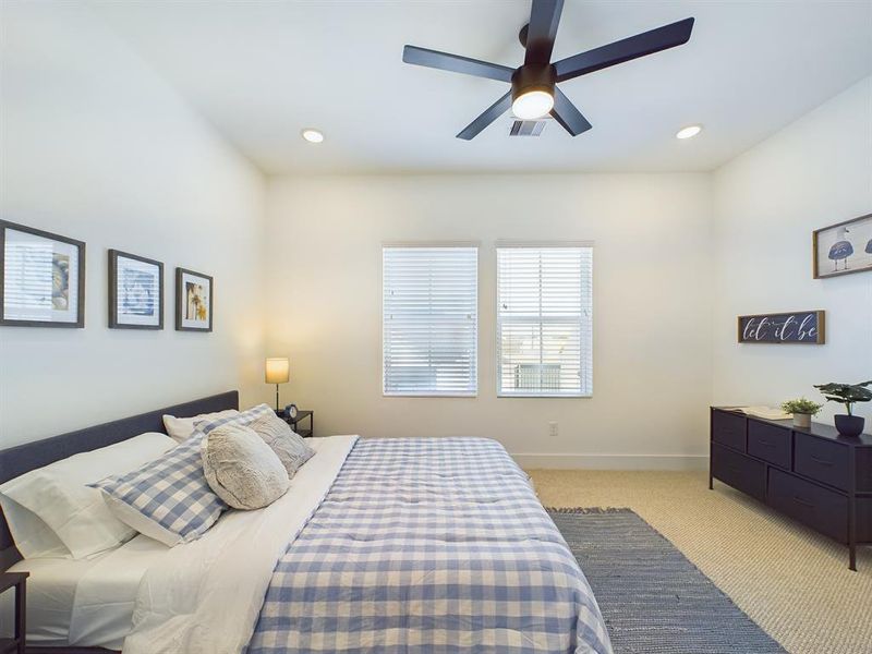 Secondary bedroom on the first floor. Photos from another community by the same builder, FINISHES & COLORS MAY VARY! Ceiling fans are not included!