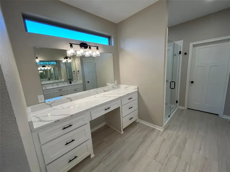 Bathroom with vanity and a stall shower