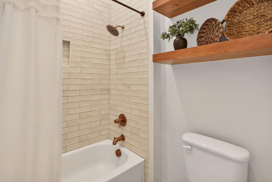 Bathroom with shower / bath combo and toilet Bathroom with shower / bath combo and toilet