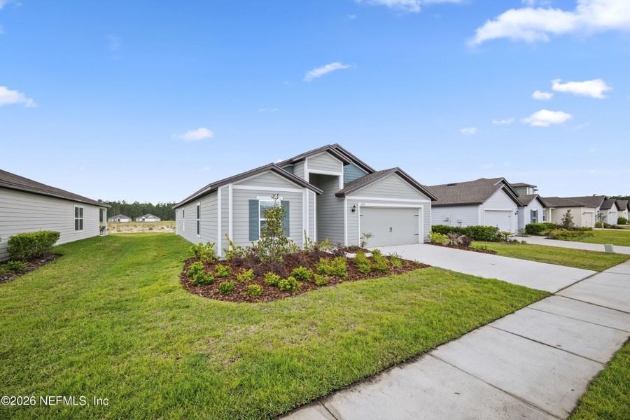 Front exterior of a new home in Westport Landing, Jacksonville, FL, highlighting curb appeal (Image 23).