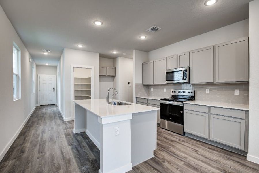 A kitchen with white cabinets. A kitchen with white cabinets.