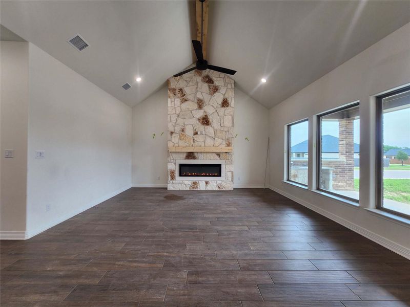 Spacious room with vaulted ceilings and wood-finish flooring