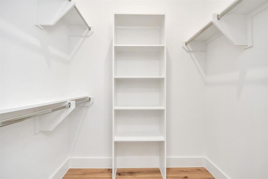 Take a look at the second Walk-in closet that epitomizes luxury and practicality. This generously sized space features built-in shelving, offering abundant room for impeccable organization. High ceilings and recessed lighting create a bright and welcoming ambiance.