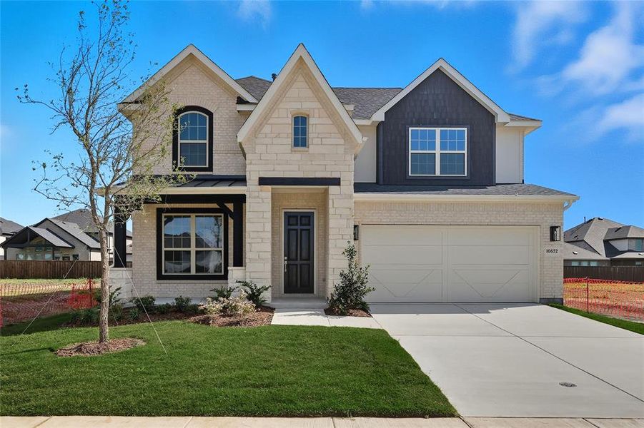 View of front of house featuring driveway, an attached garage, a standing seam roof, brick siding, and a metal roof View of front of house featuring driveway, an attached garage, a standing seam roof, brick siding, and a metal roof