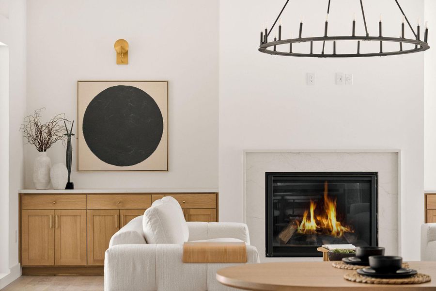 Sitting room with a high end fireplace and light wood-style floors Sitting room with a high end fireplace and light wood-style floors