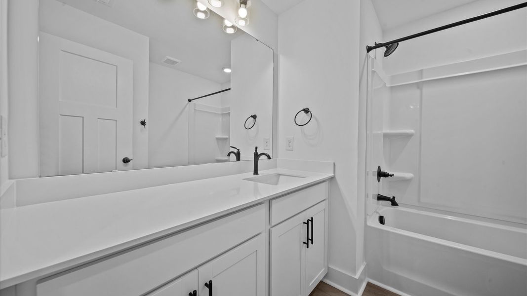 Vibrant and welcoming bathroom with elegant countertop space and polished details