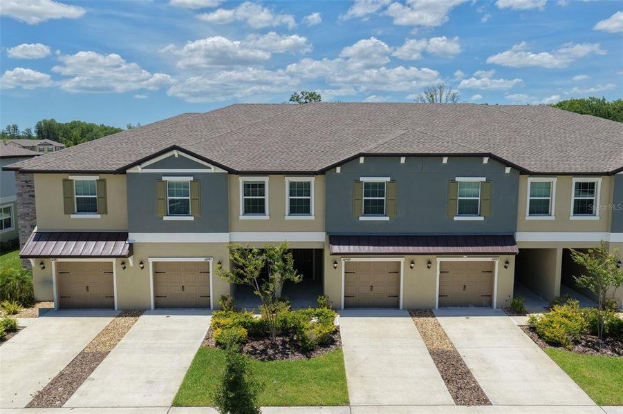 Front exterior of a new home in Angeline, Land O' Lakes, FL, highlighting curb appeal (Image 26).