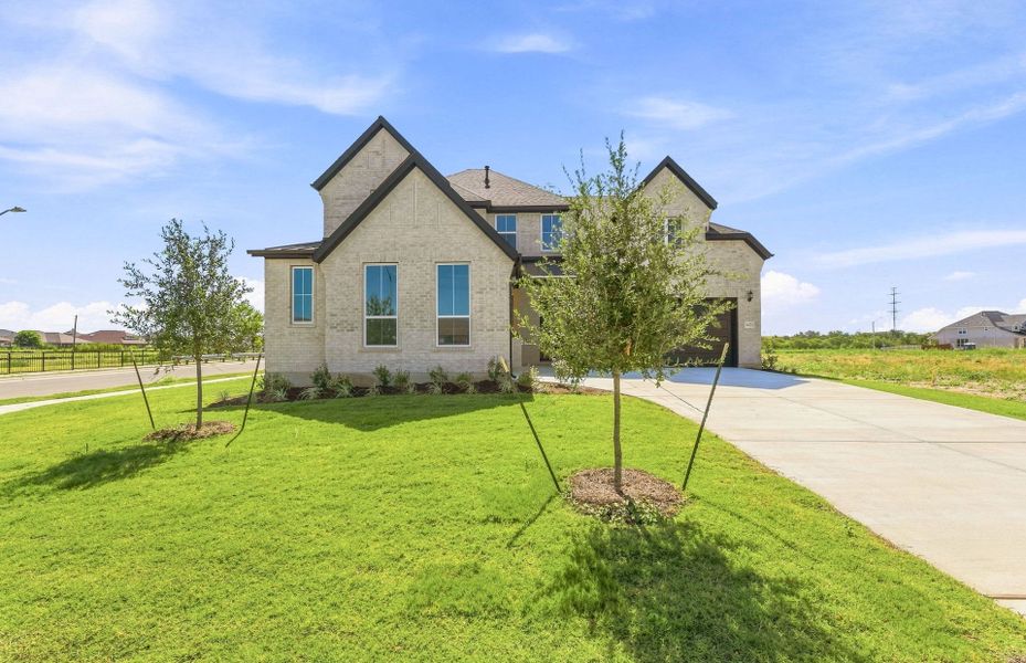 Front exterior of a new home in Kuempel Estates, Pflugerville, TX, highlighting curb appeal (Image 24).