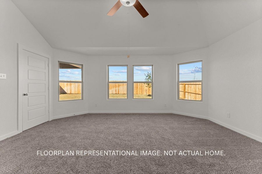 A spacious room offers ample natural light and a comfortable feel with its plush carpeting.