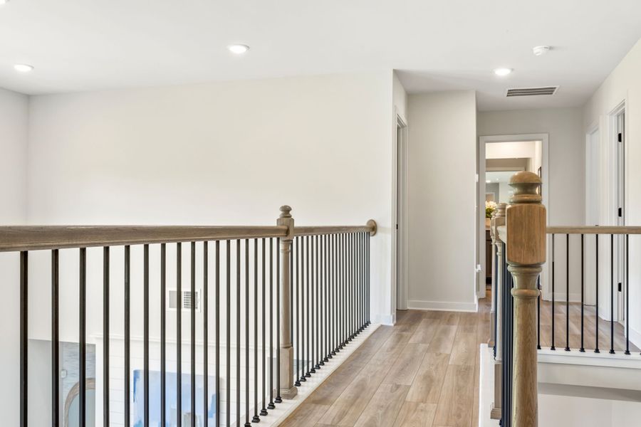 A room with a railing and a wood railing.