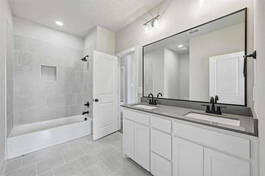 Full bath with bathtub / shower combination, double vanity, light tile patterned floors, and recessed lighting