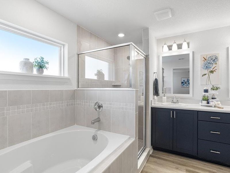 A luxe en-suite bath provides an at-home spa experience - Parker by Highland Homes A luxe en-suite bath provides an at-home spa experience - Parker by Highland Homes