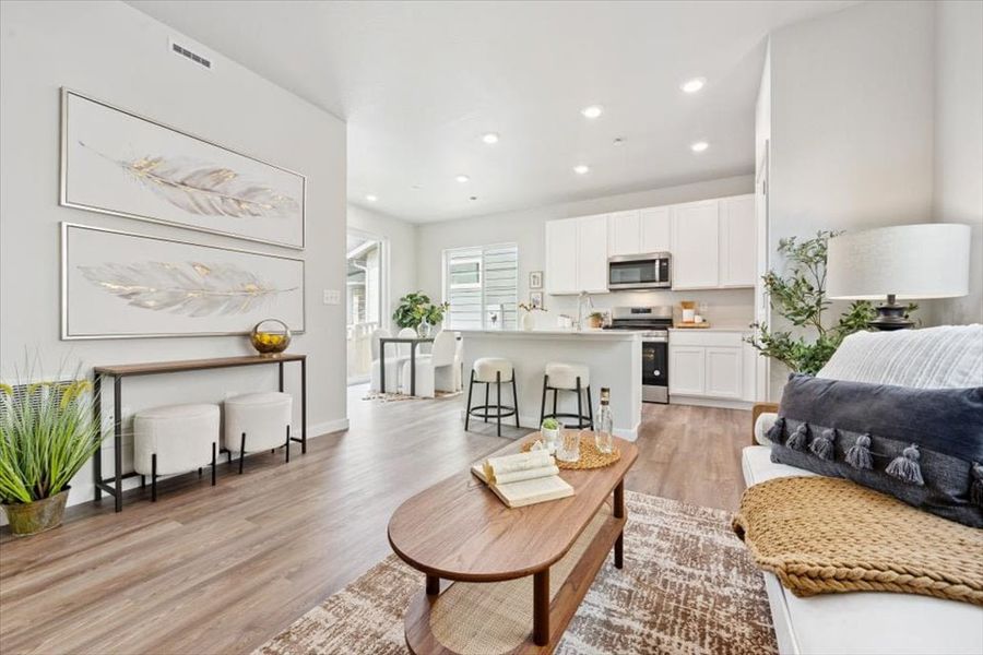 A large living room with a wood floor and a wood floor. A large living room with a wood floor and a wood floor.