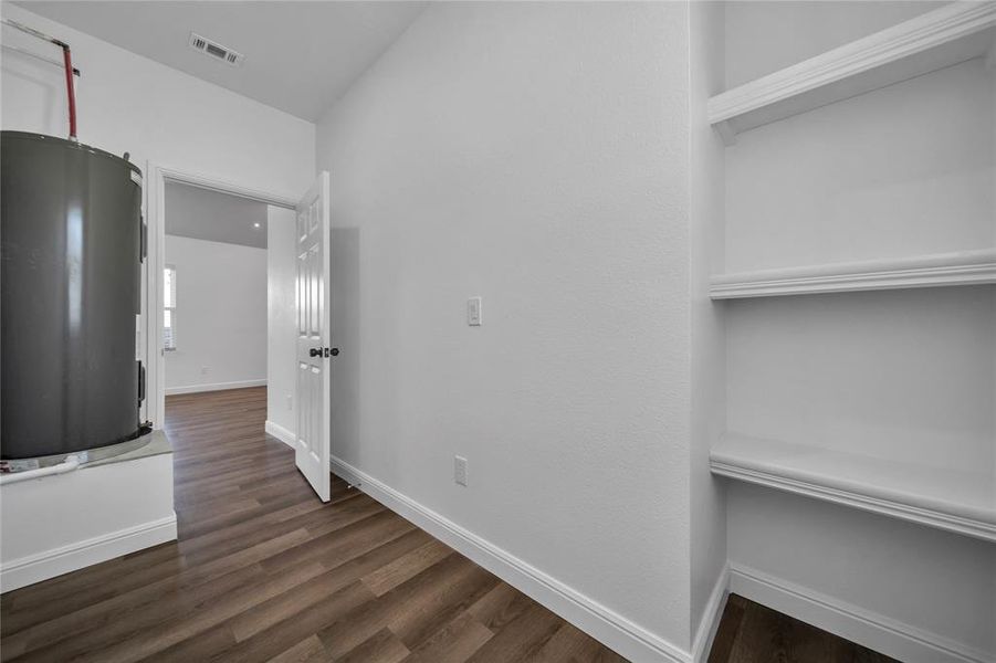 Hallway with dark wood-style floors and electric water heater