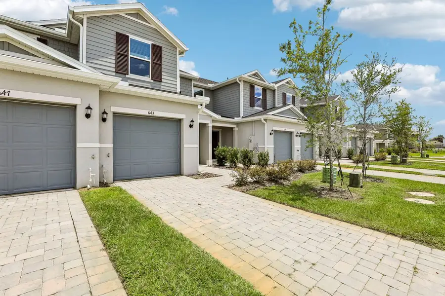 Front exterior of a new home in Reserve at Forest Lake Townhomes, Lake Wales, FL, highlighting curb appeal (Image 2). Front exterior of a new home in Reserve at Forest Lake Townhomes, Lake Wales, FL, highlighting curb appeal (Image 2).