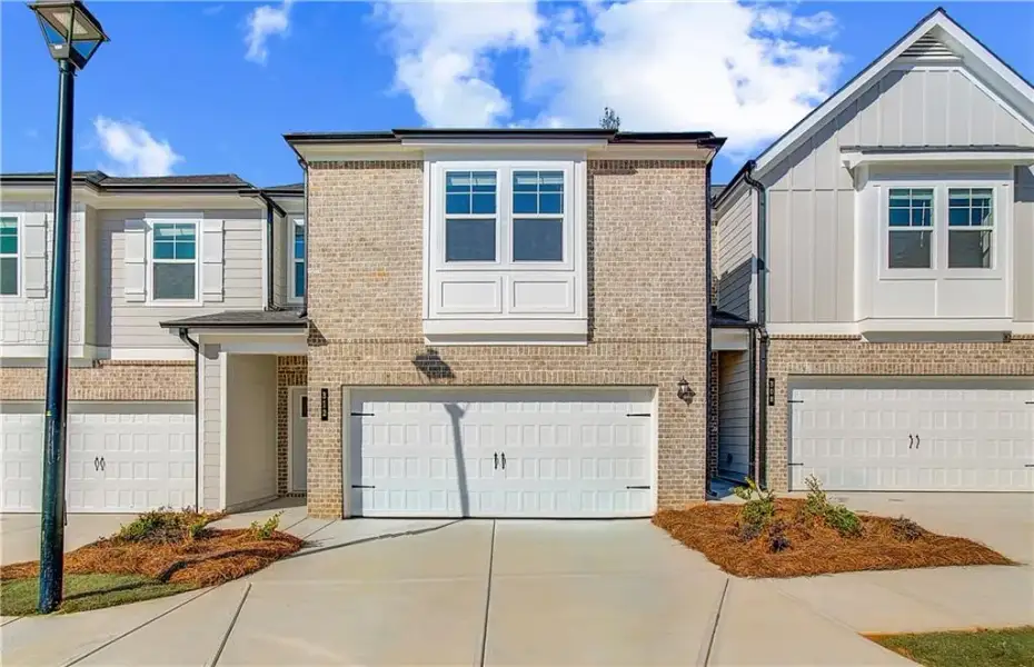 Front exterior of a new home in Diamante, Stockbridge, GA, highlighting curb appeal (Image 2). Front exterior of a new home in Diamante, Stockbridge, GA, highlighting curb appeal (Image 2).