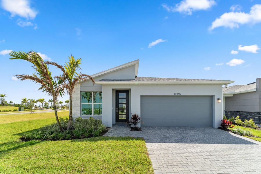 Front exterior of a new home in Tradition - Kenley, Port St. Lucie, FL, highlighting curb appeal (Image 1).