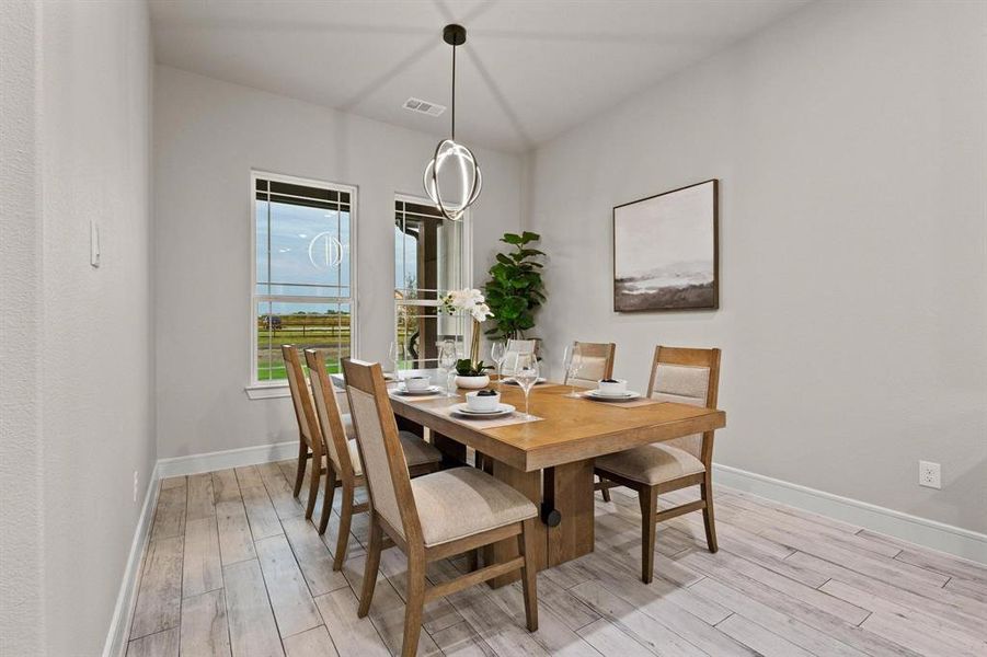 Dining room featuring baseboards and light wood-style floors