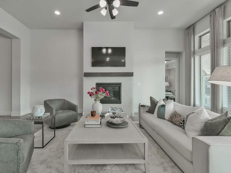 Living area with recessed lighting, a glass covered fireplace, and a ceiling fan Living area with recessed lighting, a glass covered fireplace, and a ceiling fan