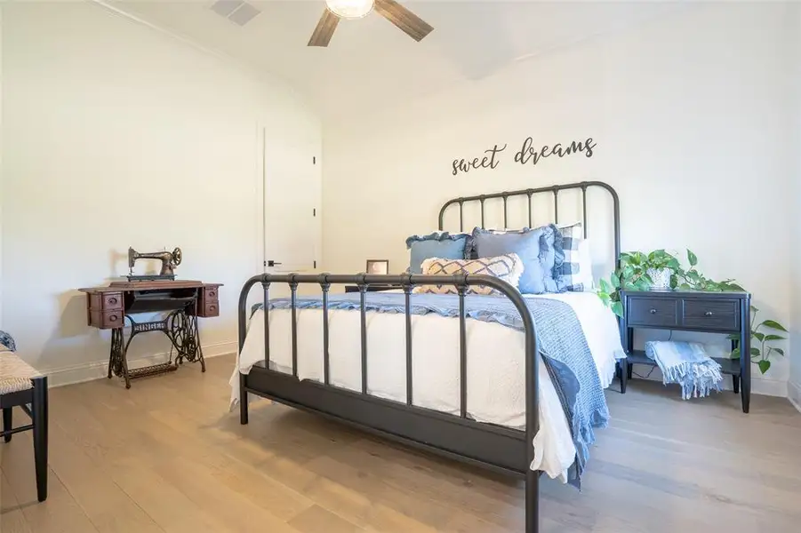 Bedroom with wood finished floors, crown molding, a ceiling fan, and vaulted ceiling Bedroom with wood finished floors, crown molding, a ceiling fan, and vaulted ceiling