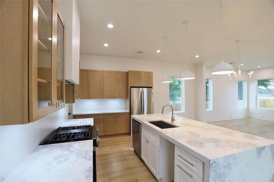 The striking island features a dual trash bin pull-out, with a drawer above designed to store trash bags for easy disposal. The open space is sized for your wine fridge—this kitchen has it all. The striking island features a dual trash bin pull-out, with a drawer above designed to store trash bags for easy disposal. The open space is sized for your wine fridge—this kitchen has it all.